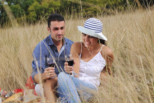 happy young couple enjoying  picnic on the countryside in the field  and have good time