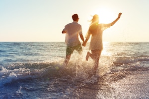 Happy young couple enjoying the sea