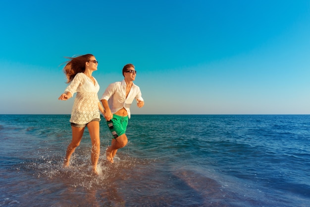 Happy young couple enjoying the sea