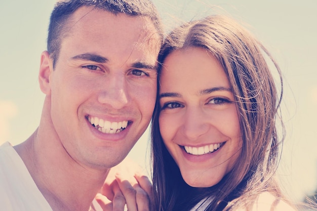 happy young couple have fun and relax  on the beach