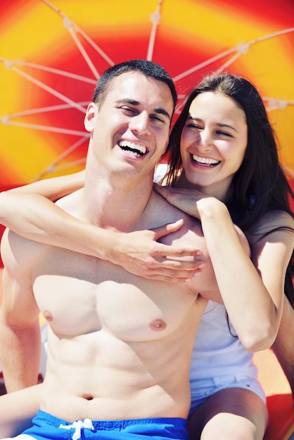 happy young couple have fun and relax  on the beach