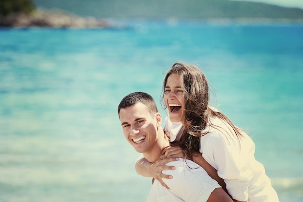 happy young couple have fun and relax  on the beach