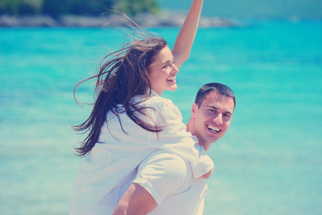 happy young couple have fun and relax  on the beach