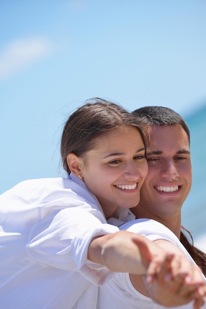 happy young couple have fun and relax  on the beach