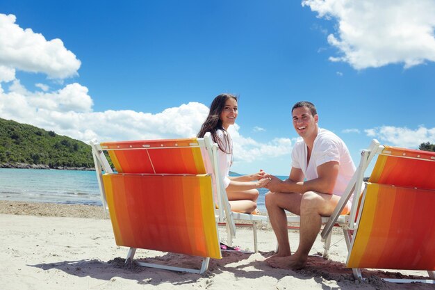 happy young couple have fun and relax  on the beach