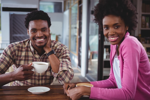 Happy young couple having coffee