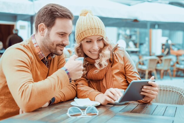 Happy young couple having fun in cafe