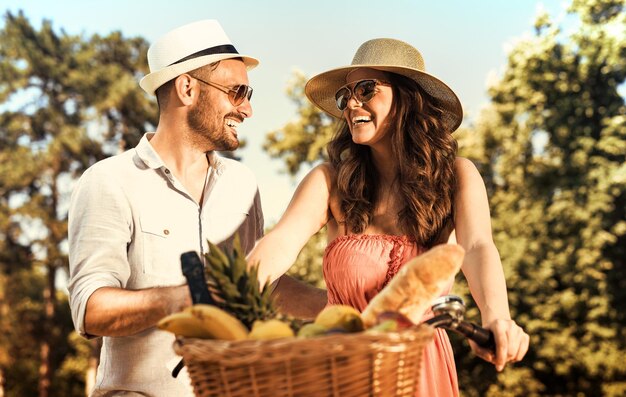 Happy young couple having picnic in the park