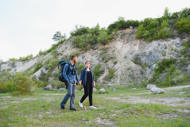 Happy young couple hiking in mountain