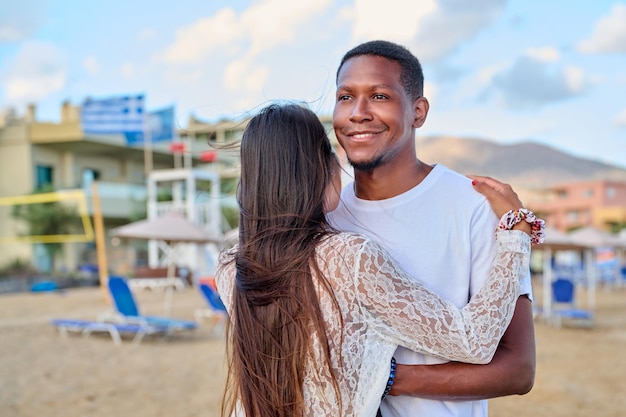 Happy young couple hugging man's face close up