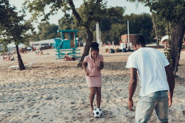 Happy Young Couple is Resting on River Beach