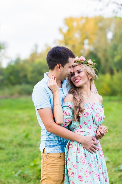 Happy young couple kissing and hugging on nature.