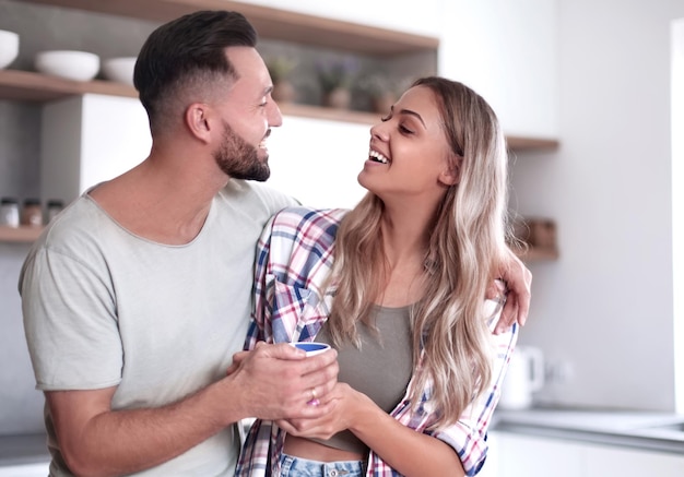 Happy young couple in kitchen in good morning time