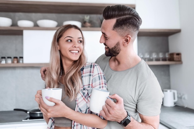 Happy young couple in kitchen in good morning time