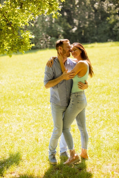 Happy young couple in love at the grass field