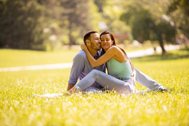 Happy young couple in love at the grass field