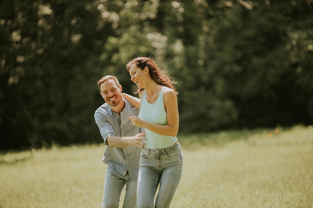 Happy young couple in love at the grass field