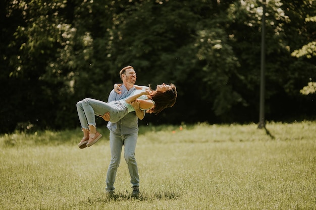 Happy young couple in love at the grass field