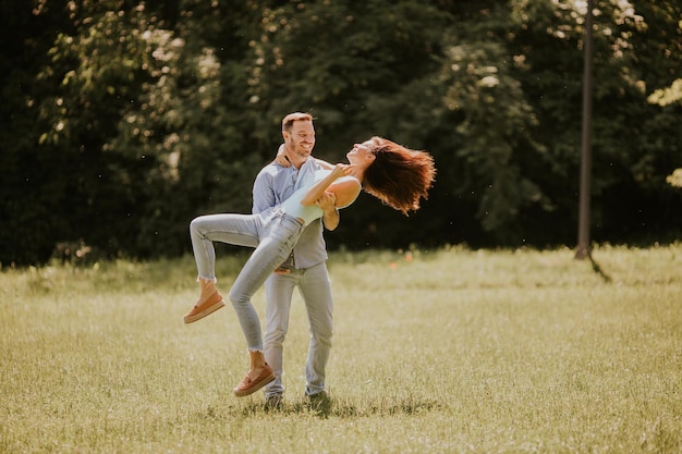 Happy young couple in love at the grass field