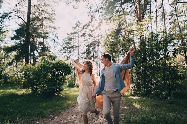 Happy young couple in love have fun while walking in the park.