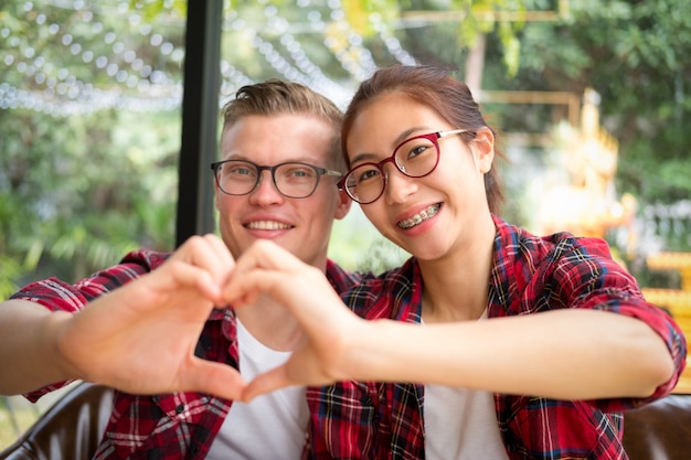 happy young couple in love hug and looking at camera and smiling