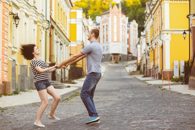 Happy young couple in love hugging at city