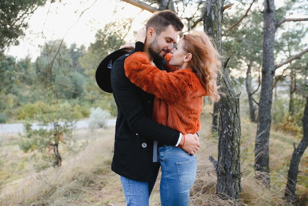 Happy young couple in love outdoor in autumn