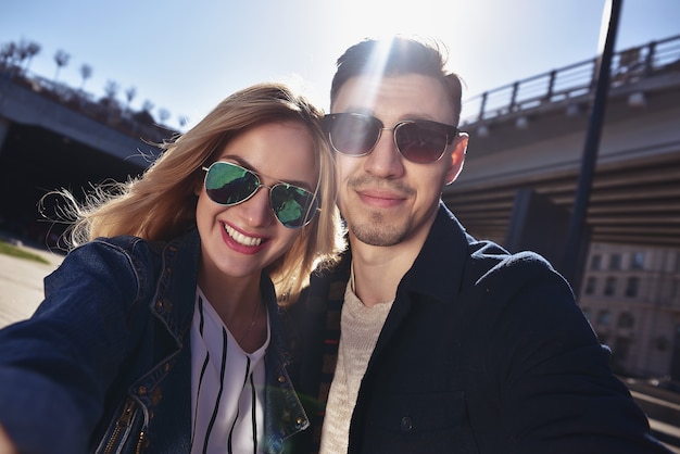 Happy young couple in love takes a selfie portrait