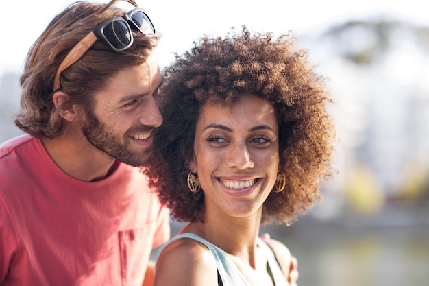 Happy young couple, man whispering into woman's ear