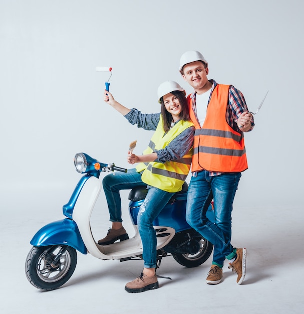 Happy young couple on motorbike. Shopping for the construction