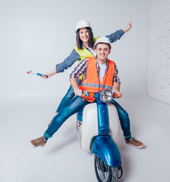 Happy young couple on motorbike. Shopping for the construction