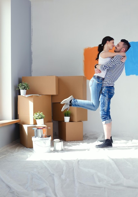 Happy young couple moving in new house young couple