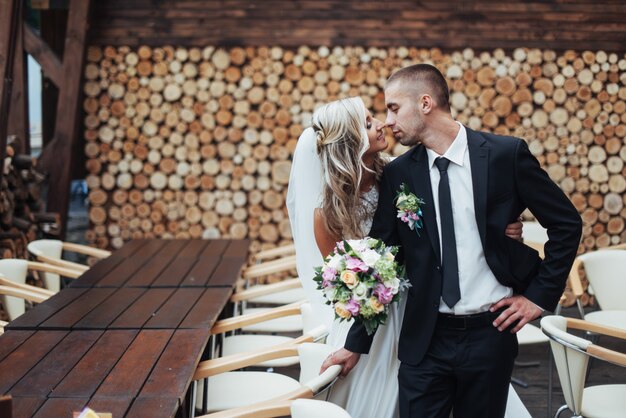 Happy young couple poses for photographers on her happiest day.