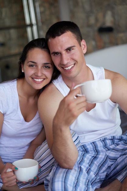 happy young couple relax and have fun in bed