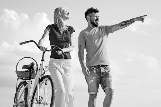 Happy young couple riding bicycles enjoying themselves on trip