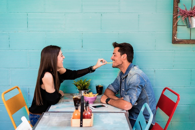 Happy young couple seating in a restaurant