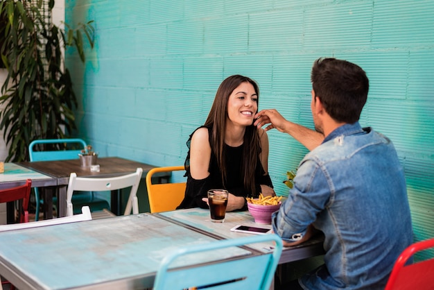 Happy young couple seating in a restaurant