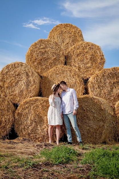 Happy young couple on straw romantic people concept beautiful landscape summer season