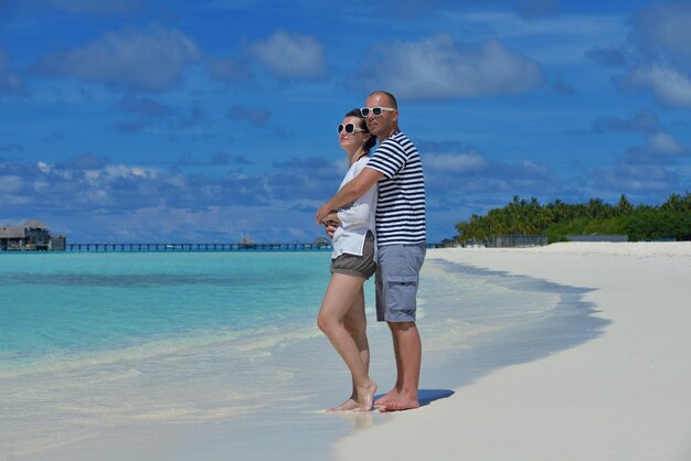 happy young  couple at summer vacation have fun and relax at beautiful sunny  day on beach