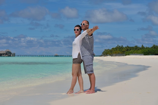 happy young  couple at summer vacation have fun and relax at beautiful sunny  day on beach