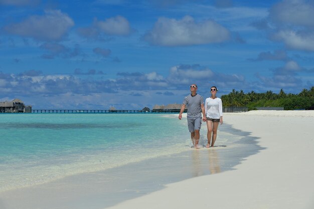 Happy young couple at summer vacation have fun and relax at beautiful sunny day on beach