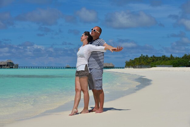 Happy young couple at summer vacation have fun and relax at beautiful sunny day on beach