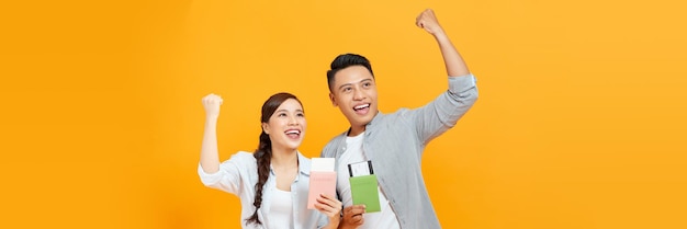 Happy young couple of tourists smiling and holding passports