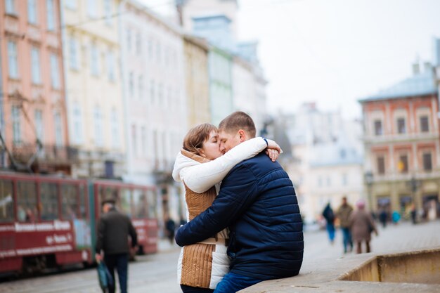 Happy young couple walking outdoors in old town