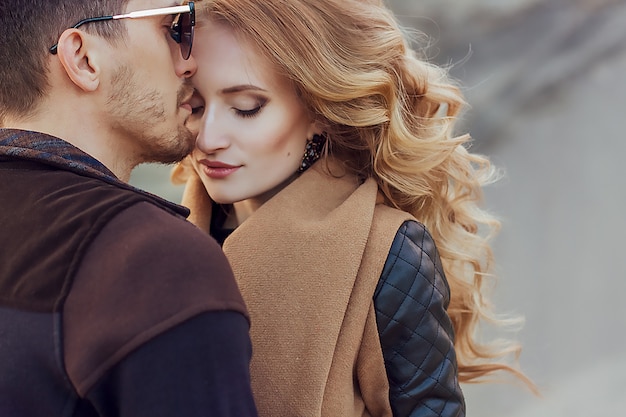 Happy young couple walking on the sandy mountains on a cloudy day