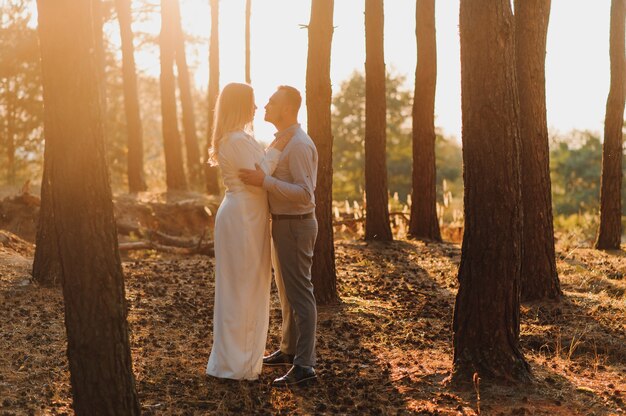 Happy young couple walking together in a green park