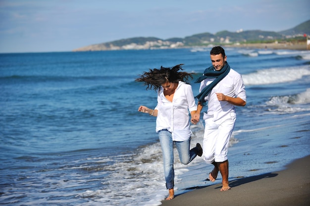 happy young couple in white clothing  have romantic recreation and   fun at beautiful beach on  vacations