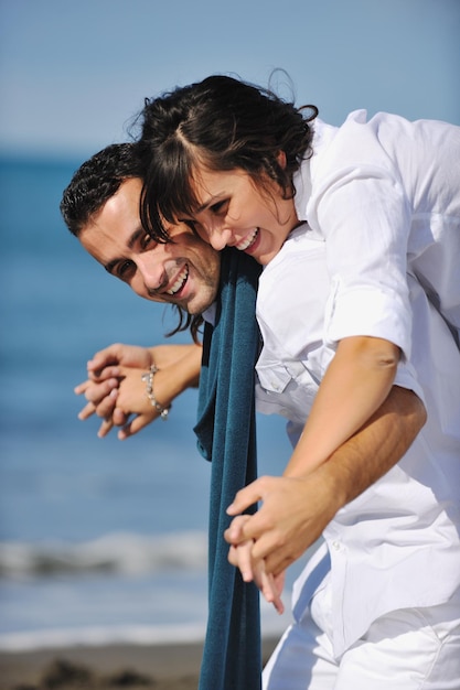 happy young couple in white clothing  have romantic recreation and   fun at beautiful beach on  vacations