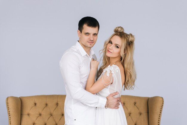 Happy young couple in white clothing