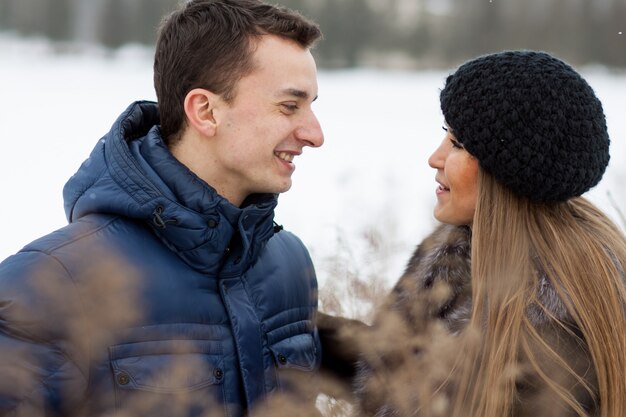 Happy Young Couple in Winter field